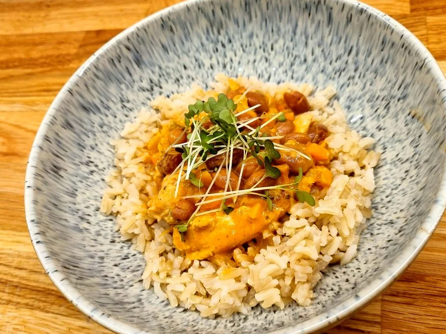 Rice and curry bowl finished with fresh microgreen garnish